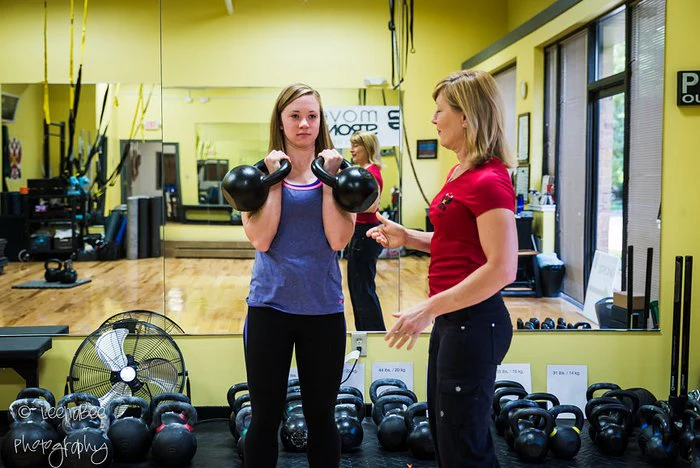 Lori Crock coaches a kettlebell student at MoveStrong Kettlebells