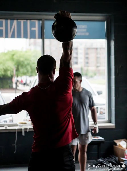 Senior RKC Robert Miller pressing a kettlebell twice the size of his head