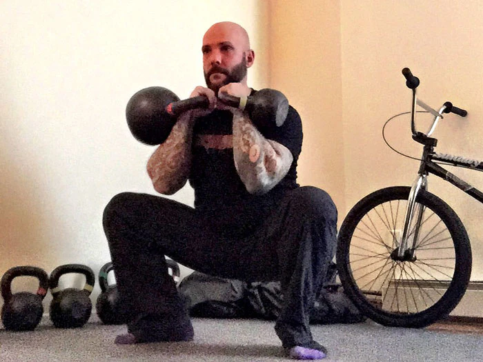 Steve Holiner Squat with Mismatched Kettlebells