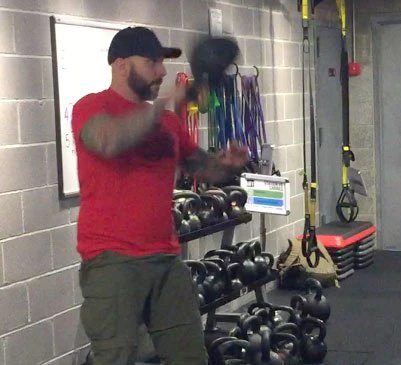Steve Holiner Kettlebell painting the fence